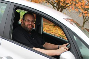 Richard Darby in the driver's seat of the instructor car seen through an open window
