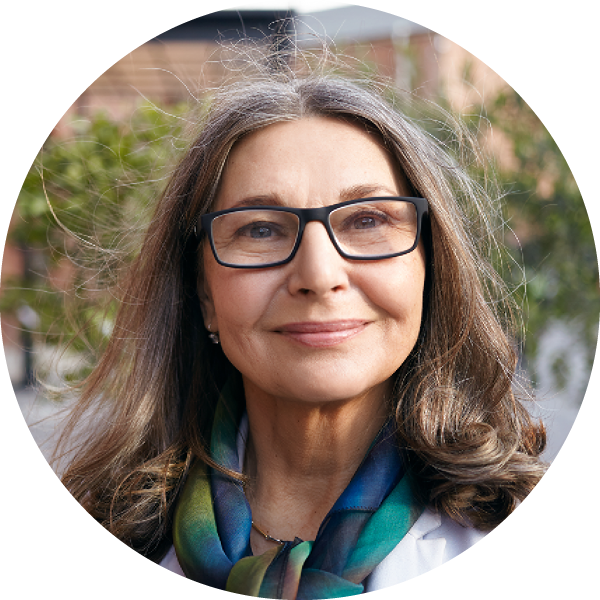 Older lady with black spectacles testimonial head shot.