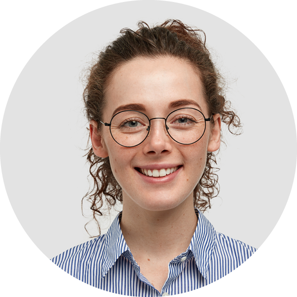 Young lady with round wire-rimmed spectacles testimonial head shot.